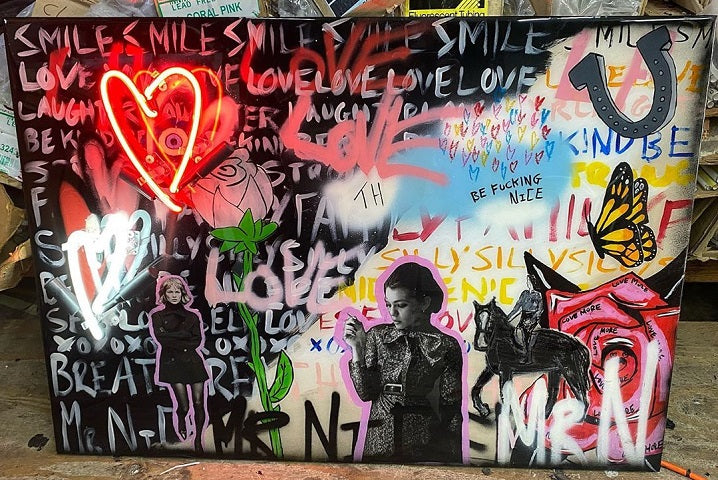 Celebrate love and niceness with custom art. This piece by Mr. Nice delivers a simple but nonetheless important message, all on a 33”x24” wooden canvas using chalk, acrylic paint, mixed media, spray paint, neon lights and finished with resin.